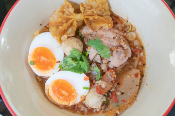Noodle tom yum with pork and egg .