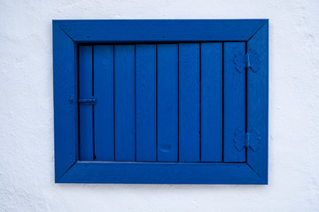Aegean Greece color window, old wooden windows on white wall.