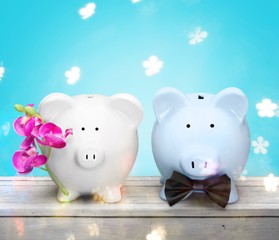 White and blue piggy banks on table on background