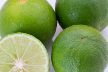 fresh green lime with whole and half with slice isolated on white background