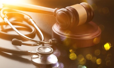Wooden gavel and stethoscope close-up view