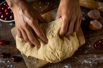 preparing a coca de cireres, a cherry flat cake