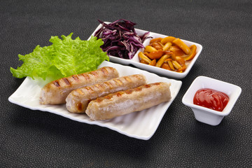 Grilled sausages served mushrooms and cabbage