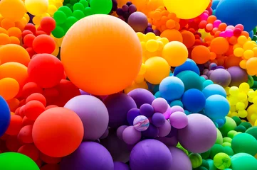  Jumble of rainbow colored balloons celebrating gay pride in a textured background © lazyllama