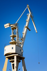 Mobile harbor cranes over blue sky. Transport and technology concept