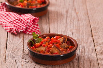 Marinated pork loin in tomato sauce.