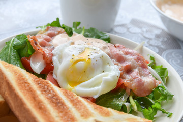 breakfast with bacon salad, egg and toasted bread
