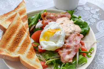 breakfast with bacon salad, egg and toasted bread