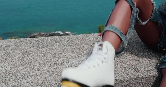 Closeup leg of beautiful young girl on vintage roller skates during sunny summer day