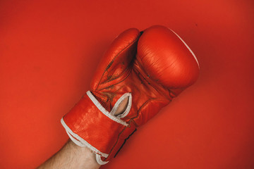red faded boxing gloves on red background.