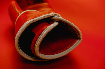 red faded boxing gloves on red background.