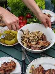 women hand bbq, eating healthy fresh salad and barbecue meat at outdoor barbecue garden party gathering, selective focus
