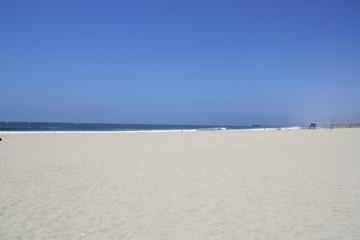 Empy beach with white sand under a blue sky