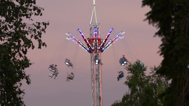 The attraction spinning carousel on a high tower
