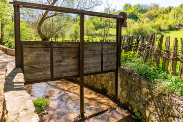 Wooden dam on a stream. Old watergate.