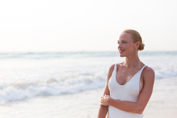 Fototapeta na wymiar Model on the beach in white dress 