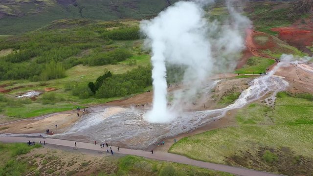 Flying above Strokkur geysir in the moment of eruption, Iceland, 4k aerial drone view