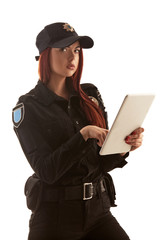 Redheaded female police officer is posing for the camera isolated on white background.