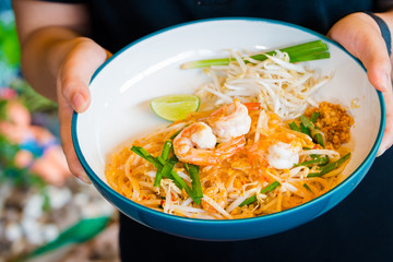 Pad Thai delicious stir fried is popular noodle food Thai traditional Style the favorite famous street food is Thailand national dishes on wooden table