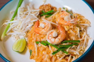 Pad Thai delicious stir fried is popular noodle food Thai traditional Style the favorite famous street food is Thailand national dishes on wooden table