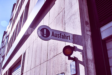Garage of an office building with holding the sign and gate with gate and sign in german Ausfahrt...