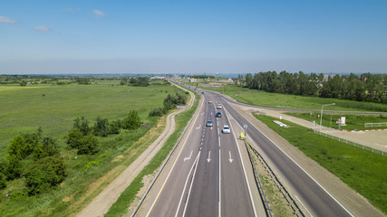 Aerial flying under highway traffic road with cars and truck