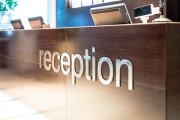 Reception area of modern hotel with computers.