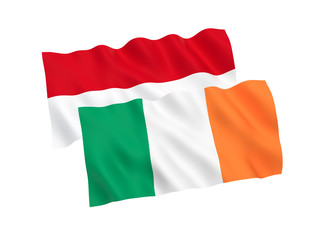 National fabric flags of Indonesia and Ireland isolated on white background. 3d rendering illustration. 1 to 2 proportion.
