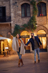 Tourist couple in love walking on street together..