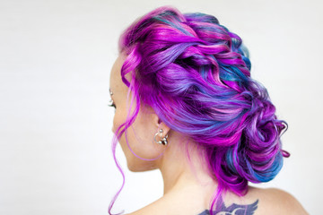 Fototapeta premium Elegant hairstyle of curls on long colored hair, styling. Bright color coloring, concept.