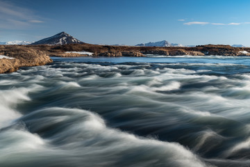 River waves with a mountain background