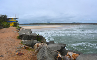 Noosa main beach on a cloudy day - a famous tourist destination on Sunshine Coast  (Queensland, Australia).