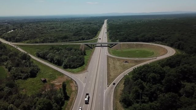 Aerial view of highway cloverleaf interchange seen from above.