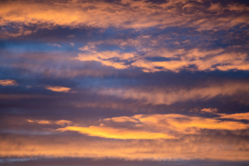 Dramatic sunset sky panorama with burning colourful clouds background. Idyllic cloudscape backdrop at dawn. Majestic cloud scenery.