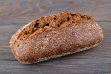 Black bread on a wooden table