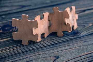 wooden puzzle on a wooden background. interaction, logic.