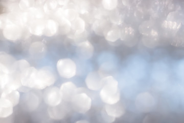 Blur abstract background silver bright sparkling white light glittering bokeh illumination