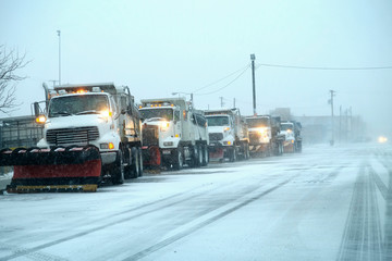 Snow Plows in Severe Blizzard Preparing for Storm