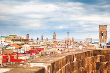 Fototapeta premium View of Barcelona cityscape from the roof of Cathedral of Holy Cross, Catalonia, Spain with dramatic sky. Sightseening and travel