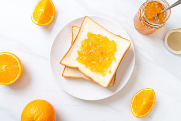 Naklejka na ściany i meble Slices of bread with orange jam