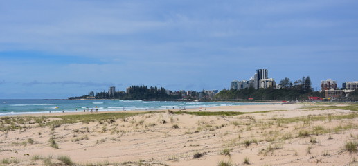 View of Coolangatta from Tugun Esplanade. People relaxing and sunbathing on Kirra Beach.