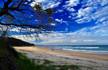 Panoramic landscape of Woolgoolga, Woolgoolga Headland and beach in New South Wales, Australia. People walking on the beach.