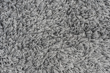 Black natural fleece carpet texture background. Dark wool fabric texture. fragment gray shaggy mat