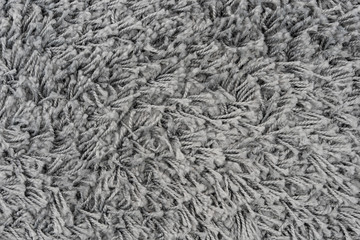 Black natural fleece carpet texture background. Dark wool fabric texture. fragment gray shaggy mat