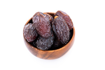 Bowl of organic dried dates, date fruit isolated on white