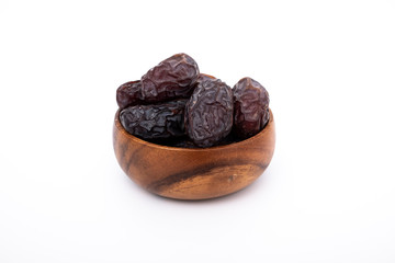 Plate of organic dried dates, date fruit isolated on white