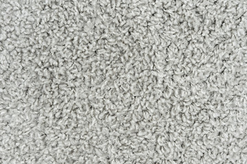White natural fleece carpet texture background. Wool fabric texture fragment shaggy mat