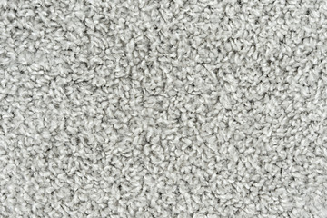 White natural fleece carpet texture background. Wool fabric texture fragment shaggy mat