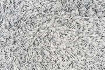 White natural fleece carpet texture background. Wool fabric texture fragment shaggy mat