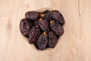 Top view of dates, date fruits are on the wooden table
